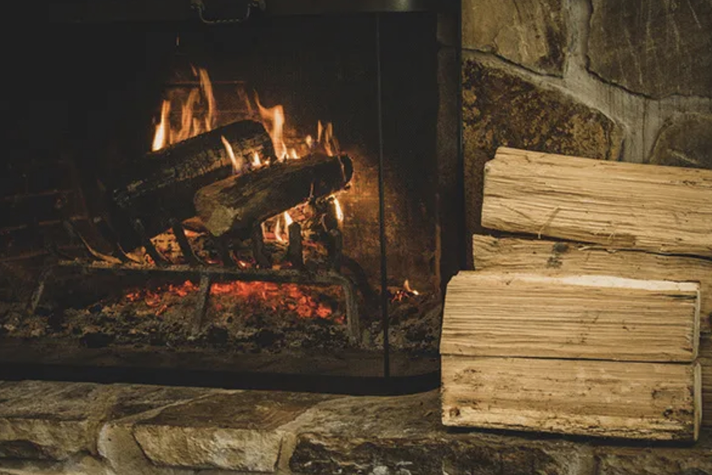 fireplace with stack of wood