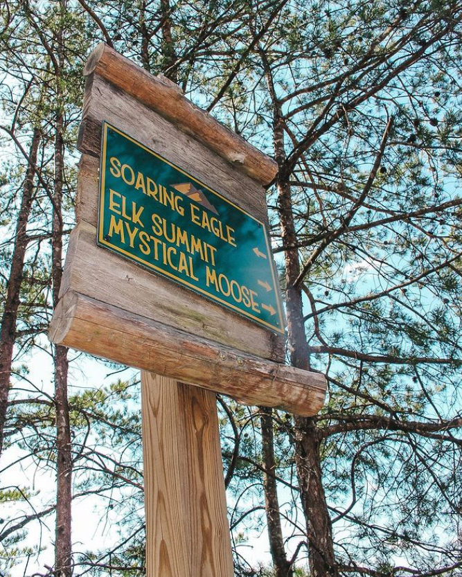 Sign with directions to Soaring Eagle, Elk Summit, & Mystical Moose cabins