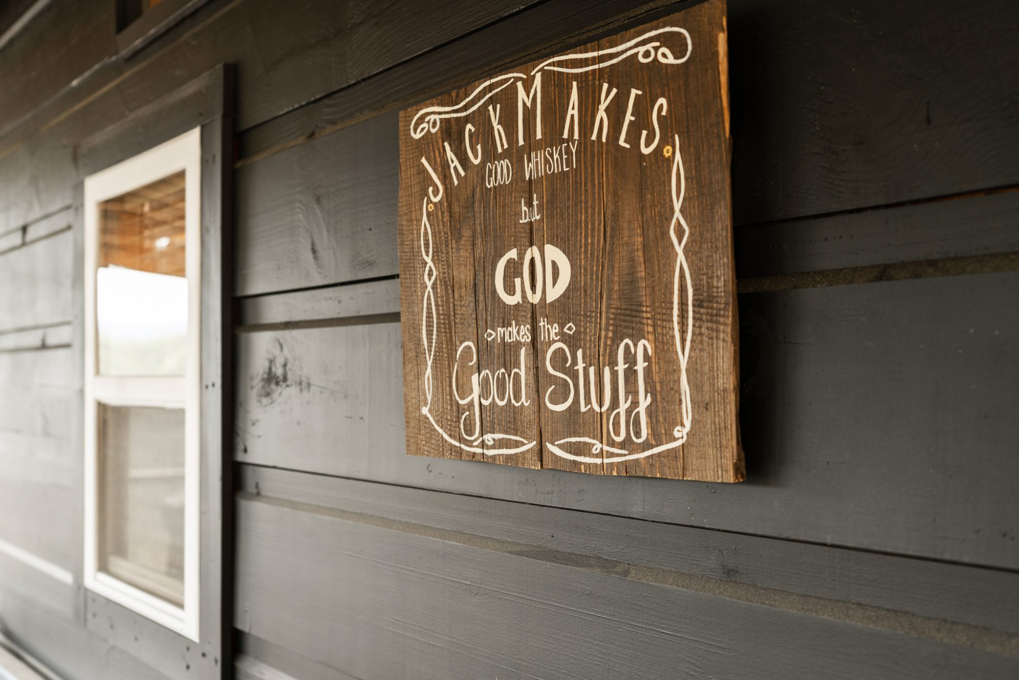 sign saying jack makes good whiskey but god makes the good stuff
